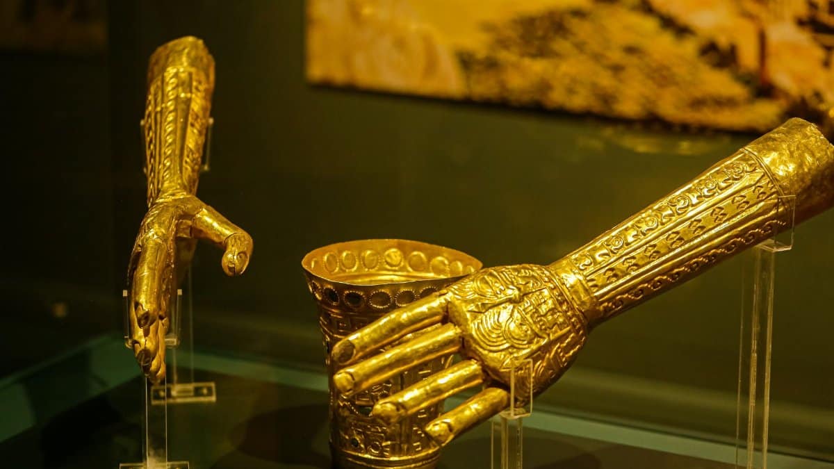 Exquisite ancient golden artifacts displayed in a museum exhibit showcasing intricate craftsmanship.
