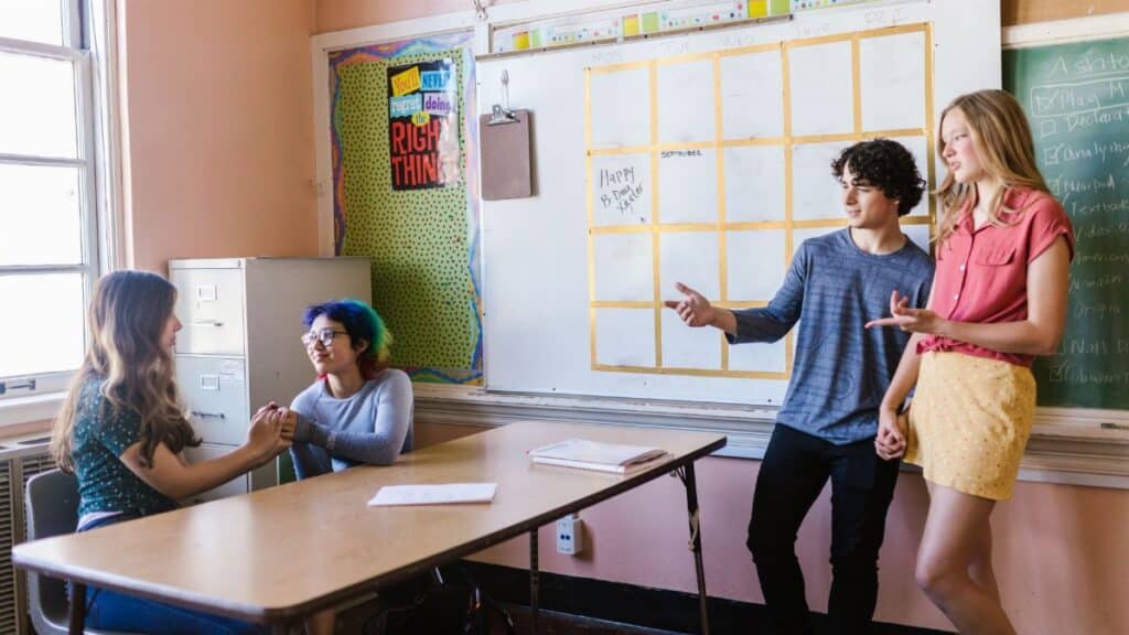 Students interacting in a high school classroom with a focus on engagement and collaboration.