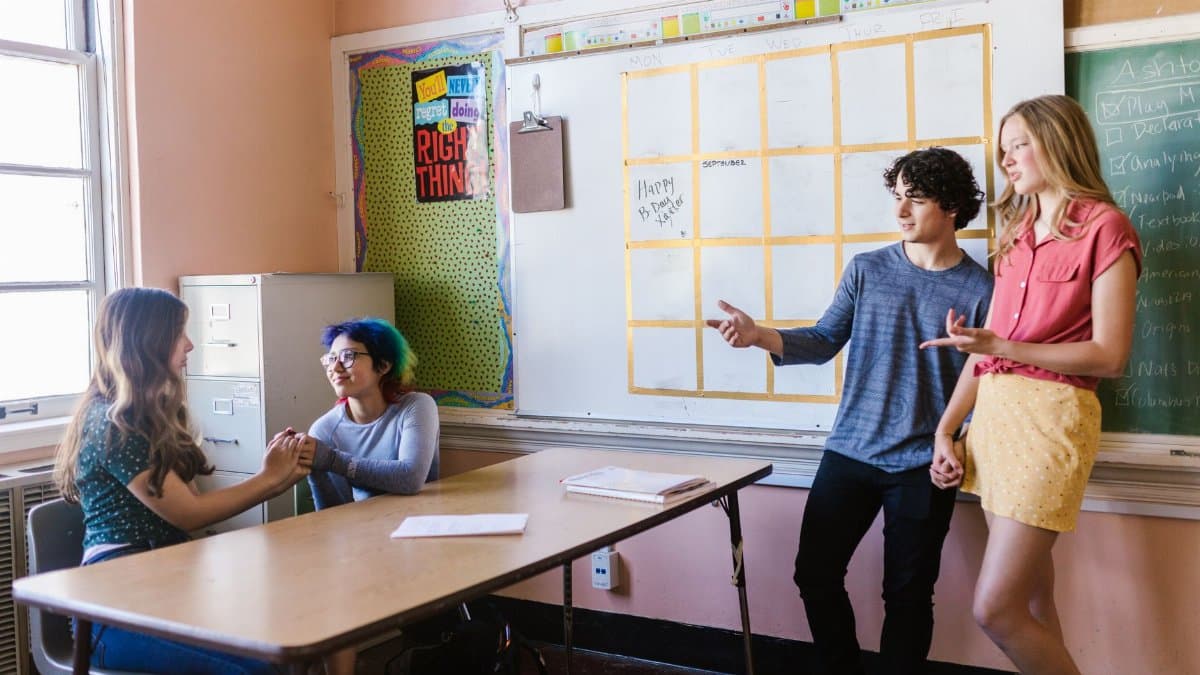 Students interacting in a high school classroom with a focus on engagement and collaboration.