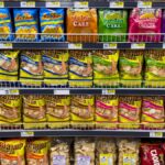 Colorful snack packages neatly displayed in a supermarket aisle showcasing Asian food variety.