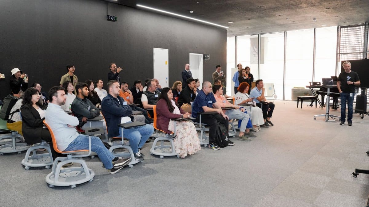 Diverse group attending business presentation in modern conference room setting.