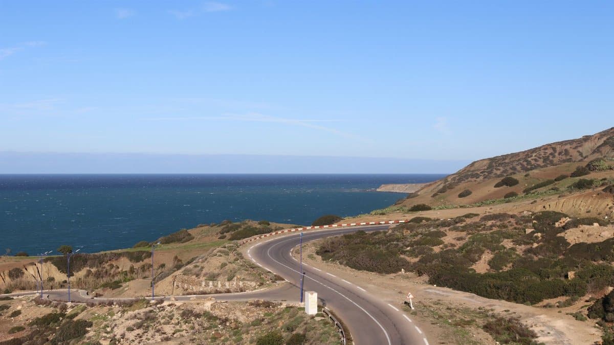 Explore the winding coastal road with ocean views in Mostaganem, Algeria.