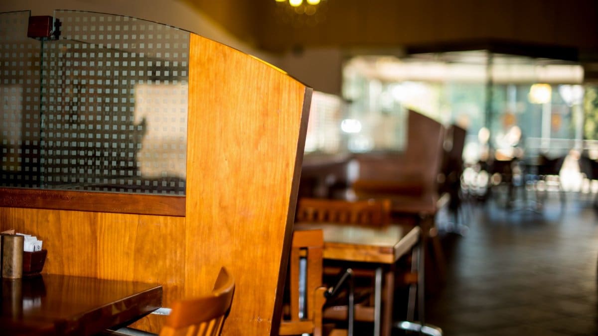 Warm, inviting restaurant interior featuring wooden tables and chairs. Perfect for dining settings.