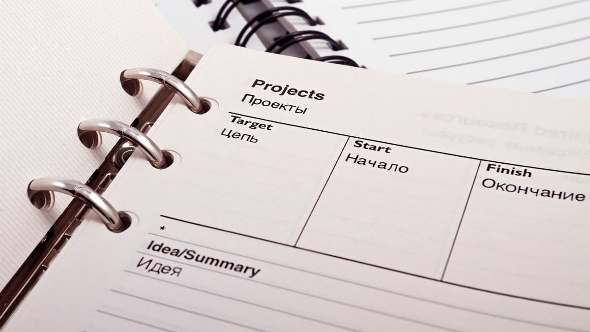 Open planner displaying project schedule with Russian-English text, ideal for office or educational content.