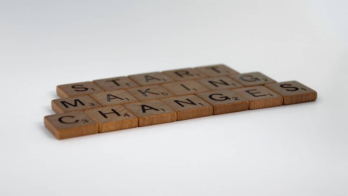 Scrabble tiles spelling 'Start Making Changes' on a white surface.