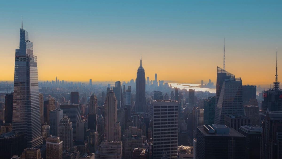 Stunning sunset view of New York City skyline featuring Empire State Building silhouette.