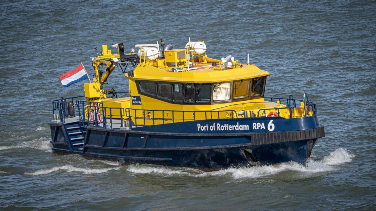 A patrol boat from the Port of Rotterdam navigating through water, showcasing maritime operations.