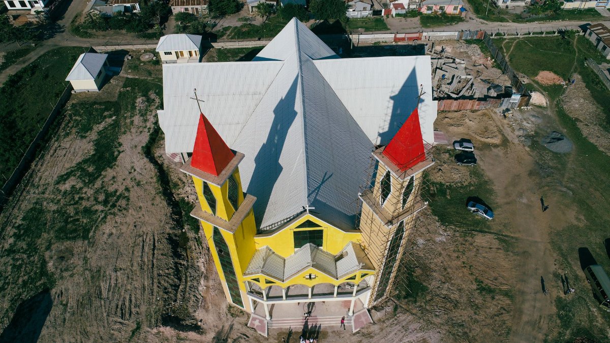 A vibrant aerial shot of a church in Dar es Salaam, Tanzania with distinctive red and yellow features.