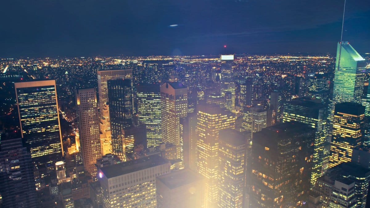 A breathtaking view of New York City's illuminated skyscrapers and skyline under a dark night sky.