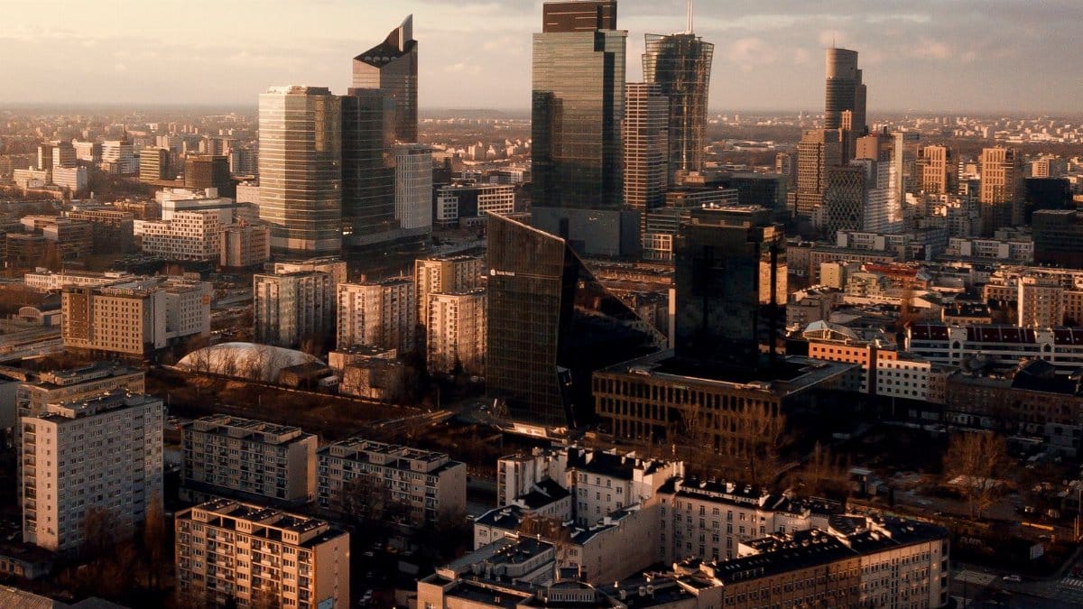 Aerial shot of Warsaw's skyline showcasing modern skyscrapers and urban landscape at sunset.
