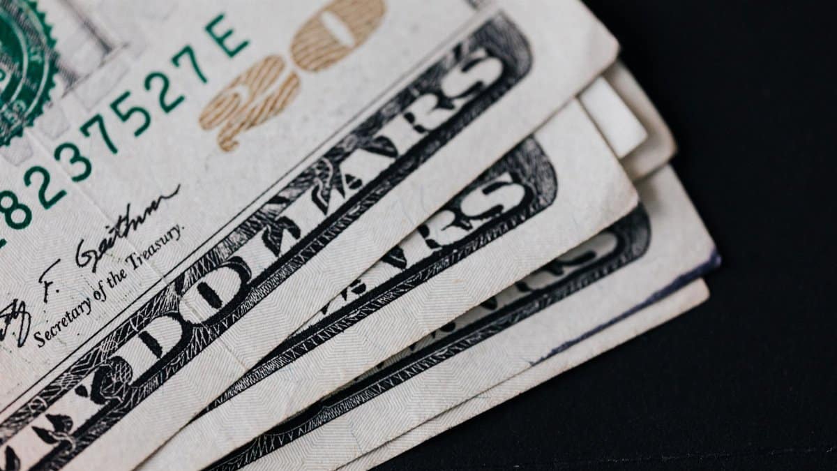 Closeup of USA 20 dollar banknotes placed on black background as national currency for business and personal financial operations