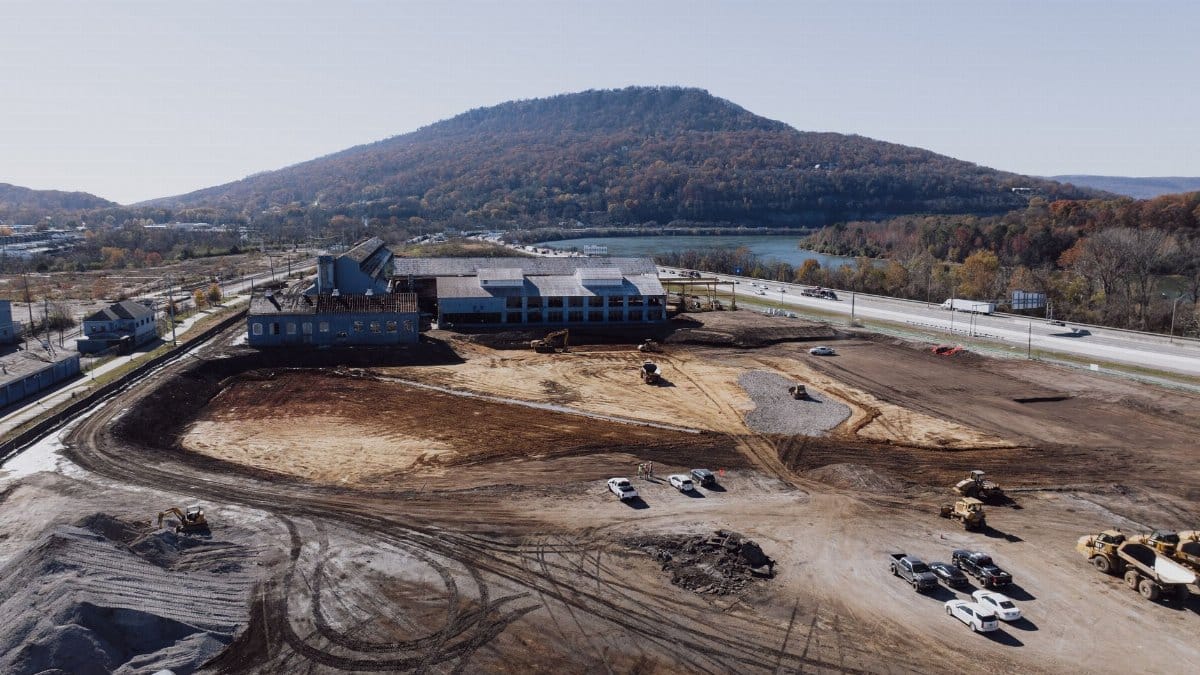 Aerial view of a construction site in Chattanooga, Tennessee with Lookout Mountain in the background.