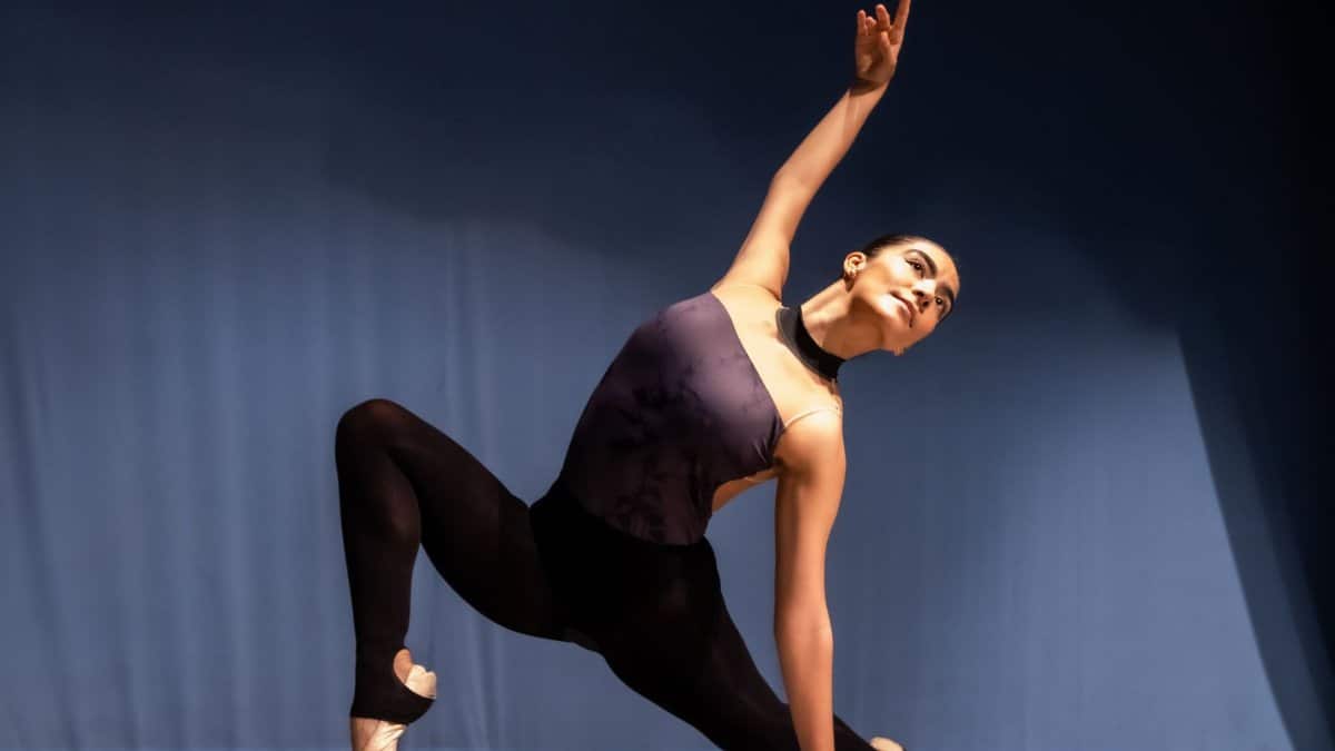 A graceful ballet dancer demonstrates flexibility and poise in a captivating stage performance.