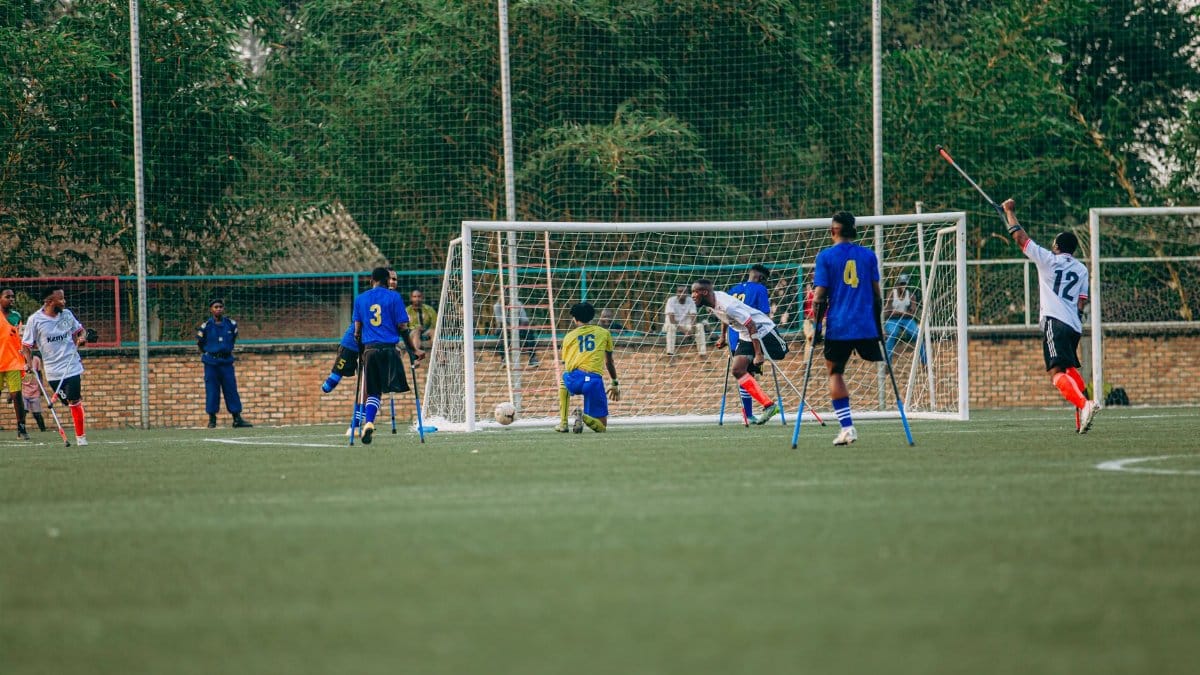 Amputee football match showcasing players in action on a sunny day, emphasizing inclusivity in sports.