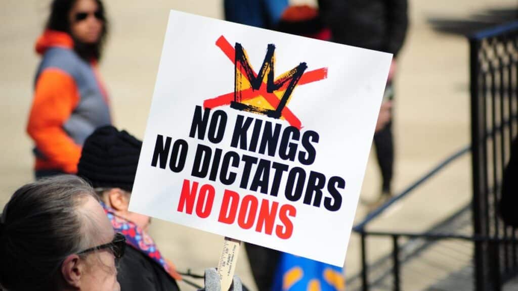 Protesters in Baltimore hold signs against dictatorial rule during a demonstration.