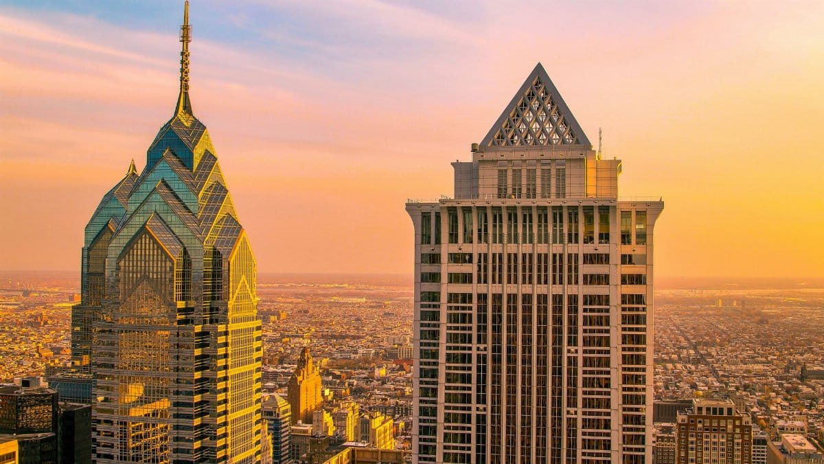 Philadelphia skyline featuring iconic skyscrapers during sunset, showcasing urban architecture and vibrant cityscape.