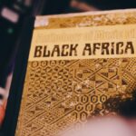 Vintage album cover titled 'Anthology of Music of Black Africa,' held by a hand, showcasing intricate designs.