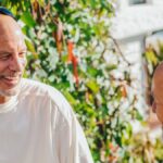 Two friends enjoying a sunny day outdoors, sharing laughter and conversation.
