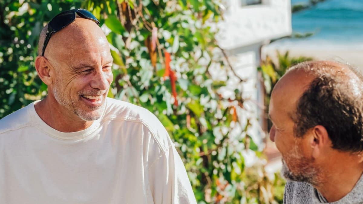 Two friends enjoying a sunny day outdoors, sharing laughter and conversation.