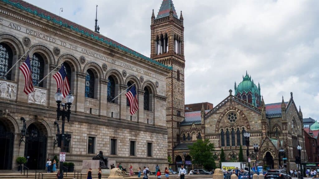 Boston Public Library and Trinity Church facade on a bustling day in Boston. A vibrant cityscape featuring historic architecture.