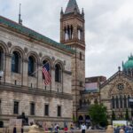 Boston Public Library and Trinity Church facade on a bustling day in Boston. A vibrant cityscape featuring historic architecture.