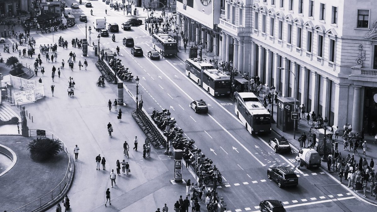 Black and white aerial view of a busy street in Barcelona, capturing daily city life.