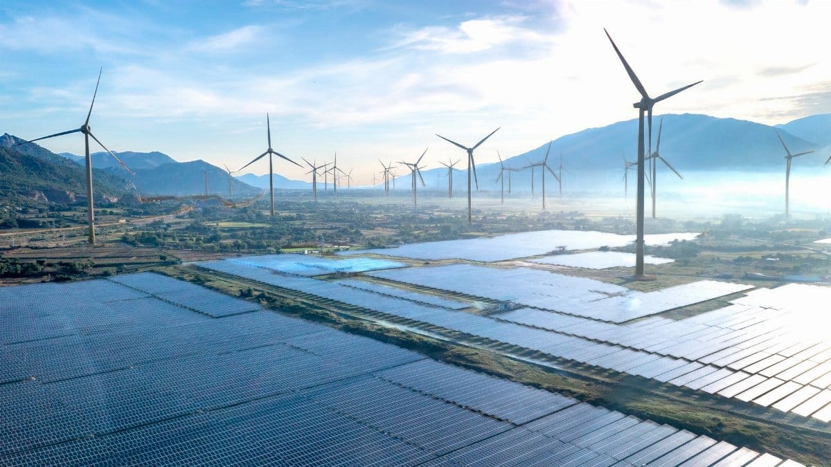 Dramatic aerial shot showcasing a wind farm and solar panels in Vietnam, illustrating the potential of renewable energy sources.