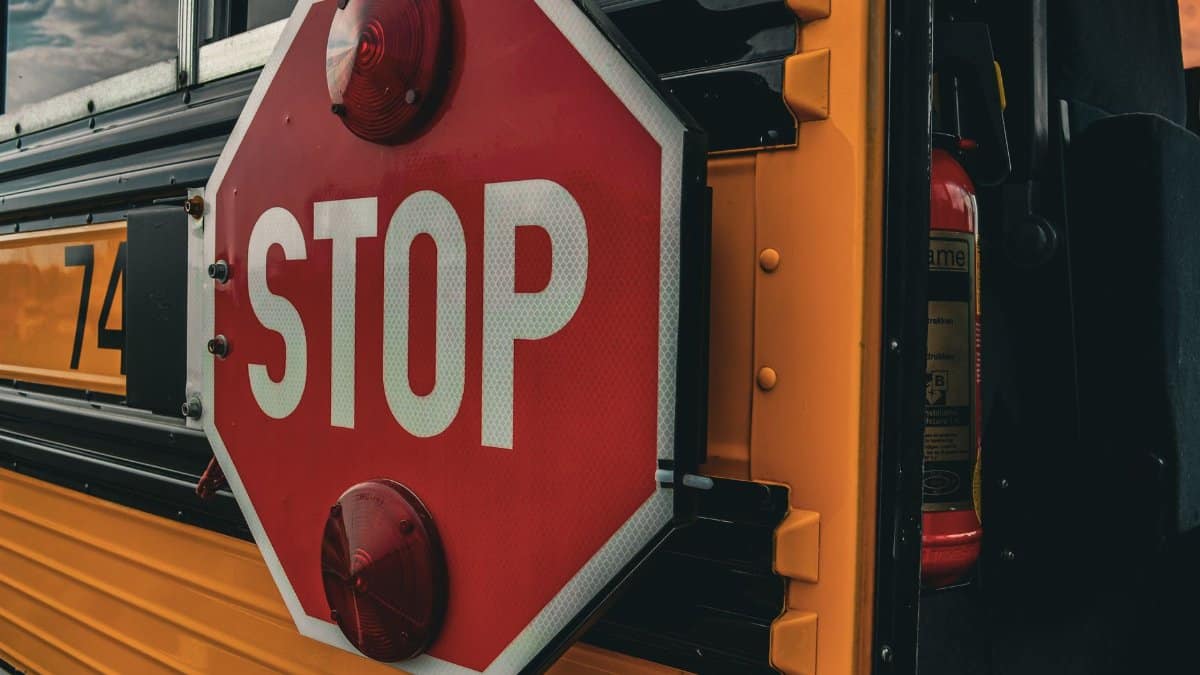 Detailed image of a 'STOP' sign on a school bus, emphasizing safety and transport.