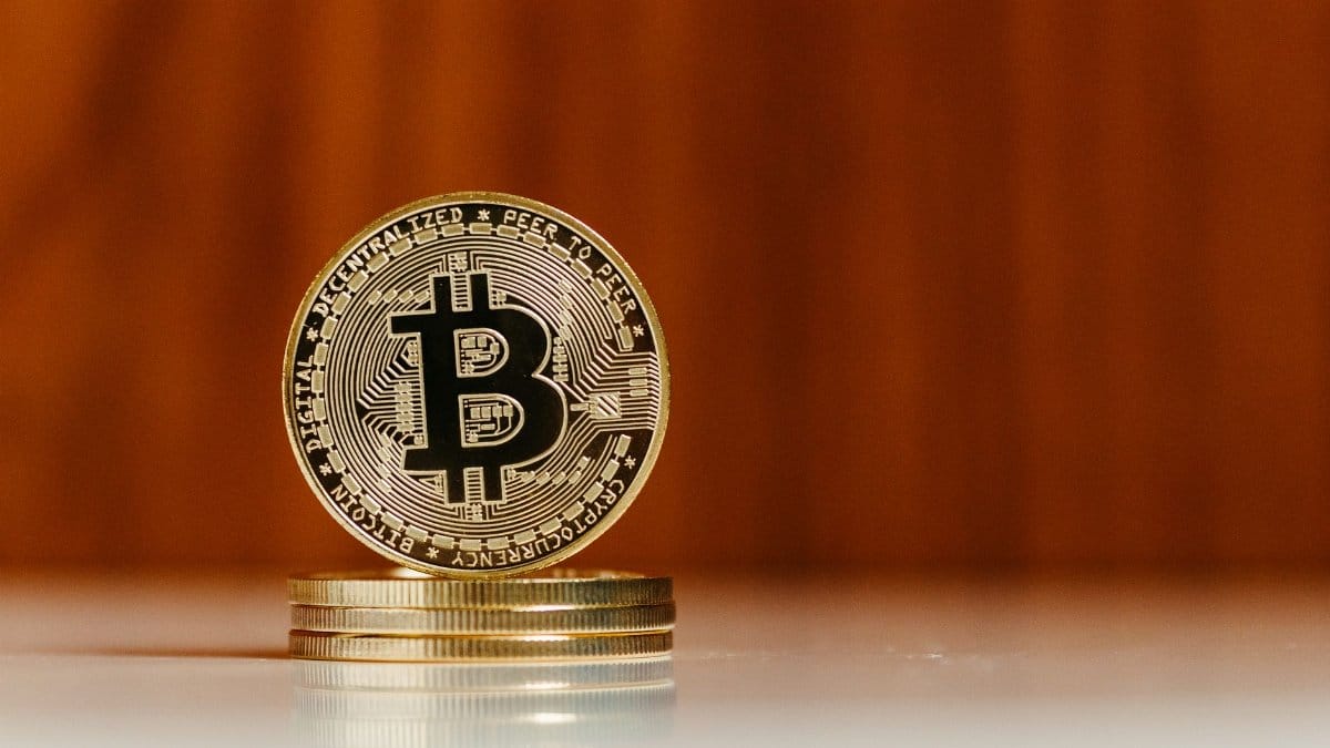 Close-up of a gold Bitcoin coin with reflective surface, ideal for financial and tech themes.