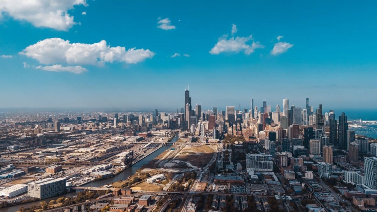 Stunning aerial shot of the Chicago skyline with clear blue skies and vibrant cityscape.