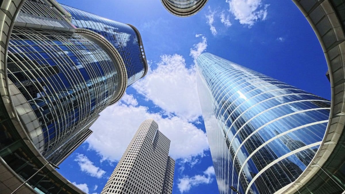 Upward view of skyscrapers against a bright blue sky in Houston, Texas.
