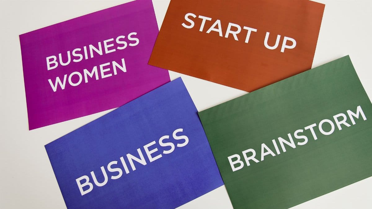 Colorful cards with business terms on a desk background.