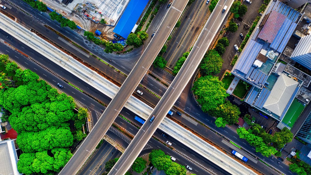A vibrant aerial view of South Jakarta's highways and greenery, showcasing urban development and infrastructure.