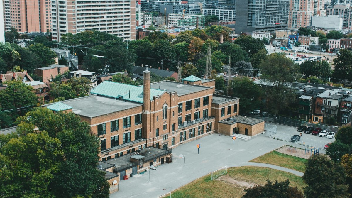 Discover an urban school within a bustling city environment. Ideal for education themes.