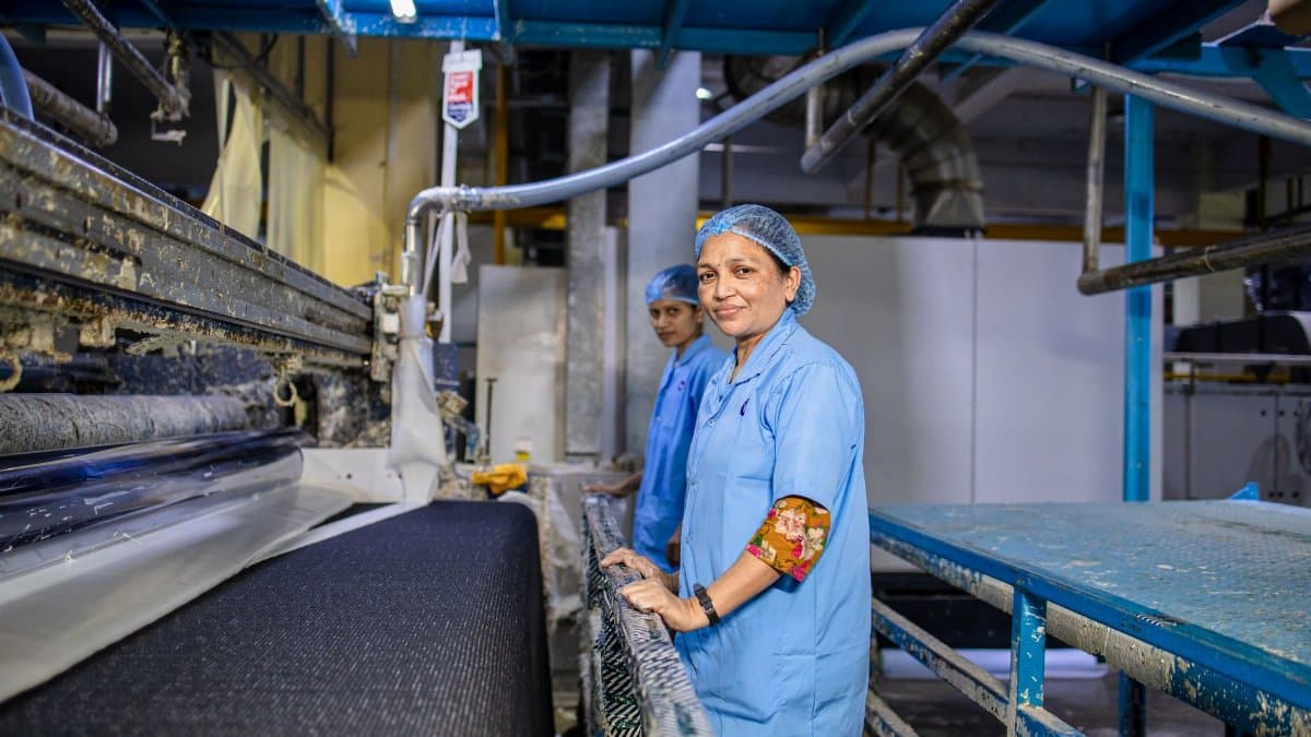 Women in a textile factory, working on machinery, showcasing teamwork and industry.