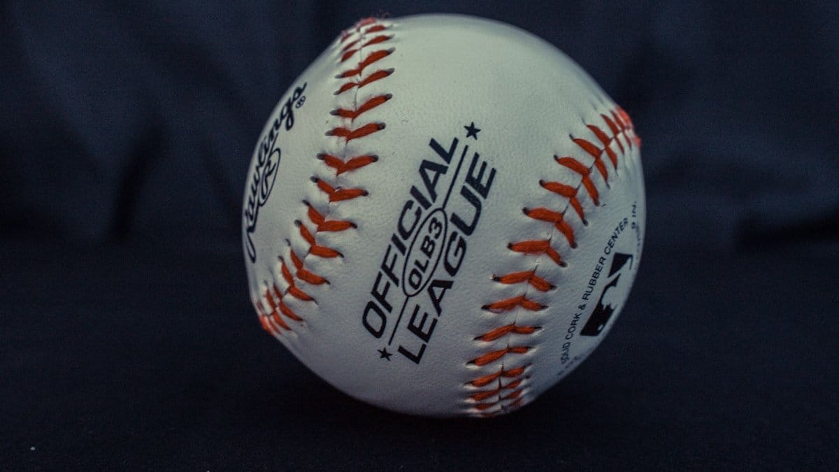 Detailed close-up of an official league baseball with visible branding and stitches.