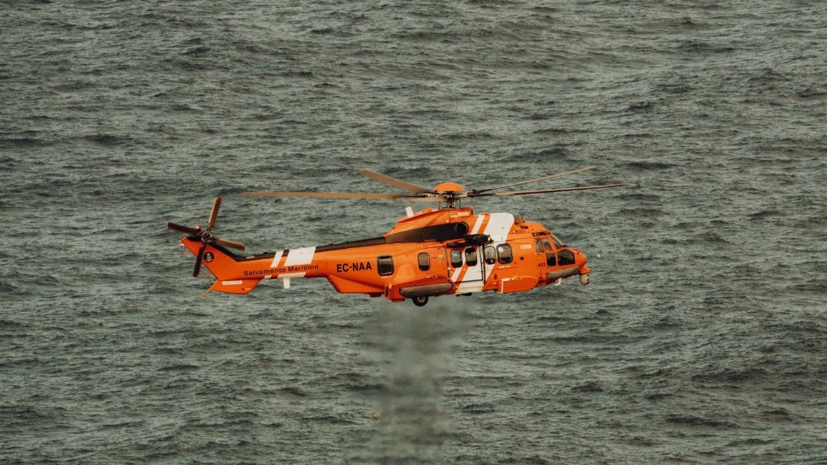 Spanish Maritime Safety helicopter flying above the ocean, offering a striking view of aerial operations.