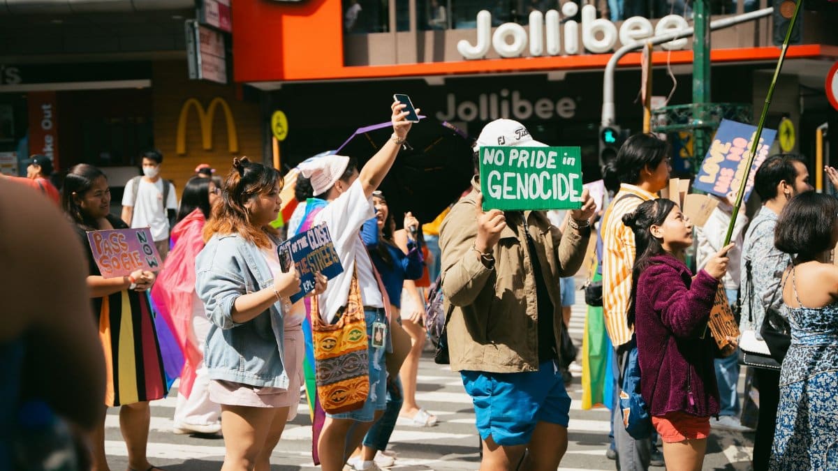 A lively street protest with diverse individuals holding signs promoting social justice.