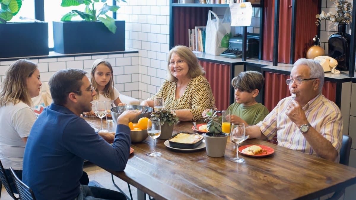 A joyful family dining together indoors, highlighting togetherness and culinary enjoyment.