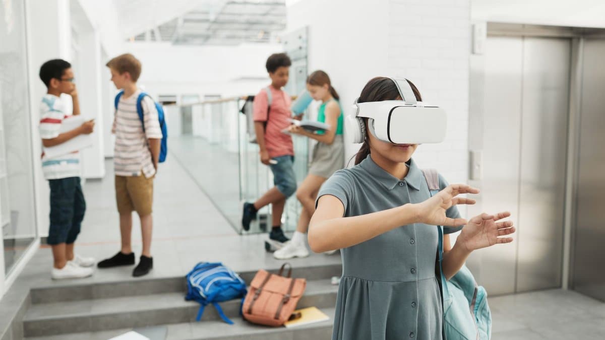 Group of students exploring virtual reality technology at a modern school setting.