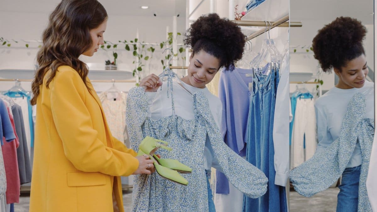 Two women exploring stylish clothing in a trendy boutique. Perfect for fashion and shopping concepts.