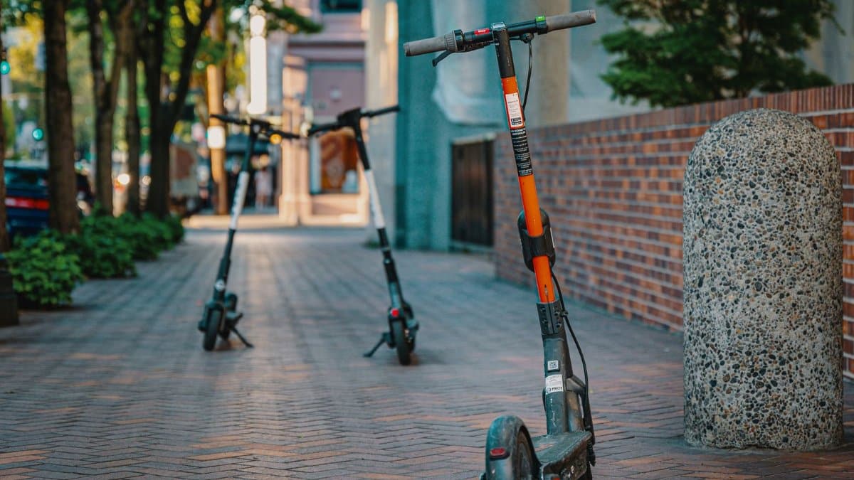 Electric scooters parked on a city sidewalk, embracing urban transportation and modern mobility.