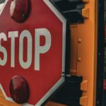 Detailed image of a 'STOP' sign on a school bus, emphasizing safety and transport.