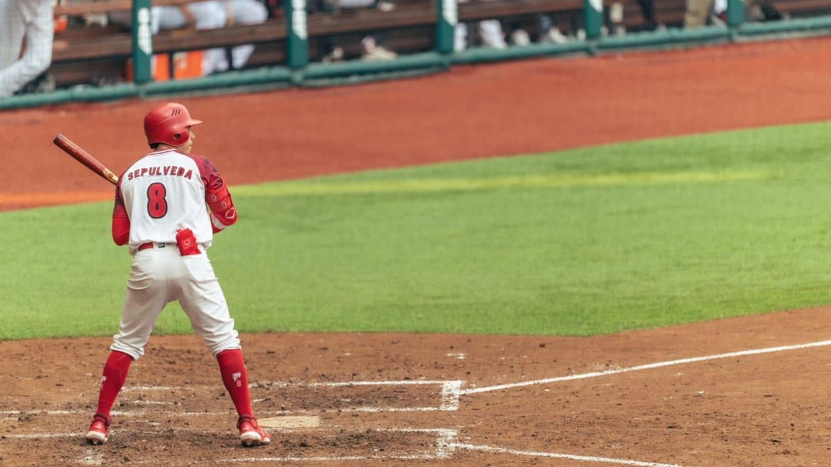 Baseball player ready to bat in a stadium game, capturing sports action and anticipation.
