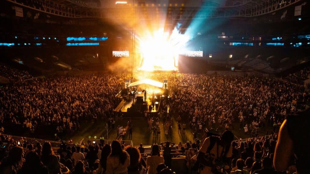 Lively concert atmosphere captures the energy of a packed crowd in a São Paulo stadium at night.