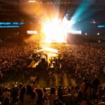 Lively concert atmosphere captures the energy of a packed crowd in a São Paulo stadium at night.