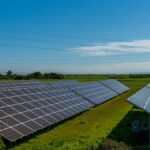 Solar panels in a lush rural field, generating renewable energy in San Rafael, CA.