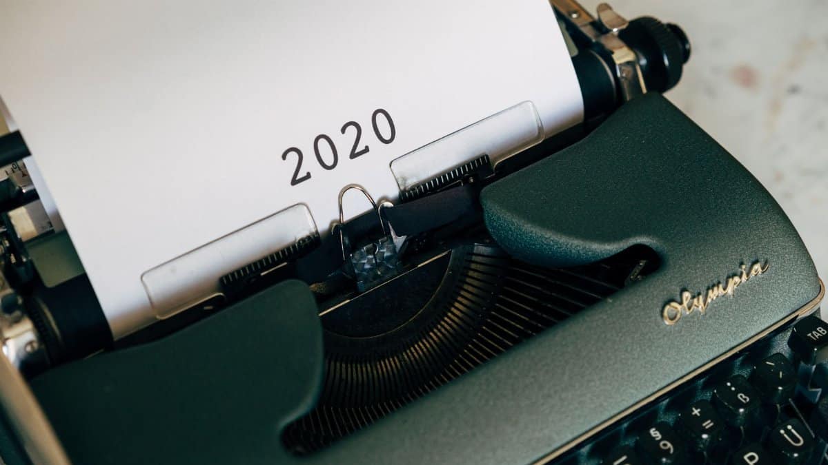 Close-up of a vintage typewriter with the year 2020 on paper, symbolizing past communication.