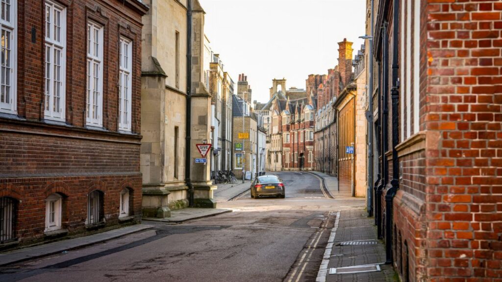 Charming street in Cambridge with historic architecture and cobblestone road.