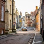 Charming street in Cambridge with historic architecture and cobblestone road.